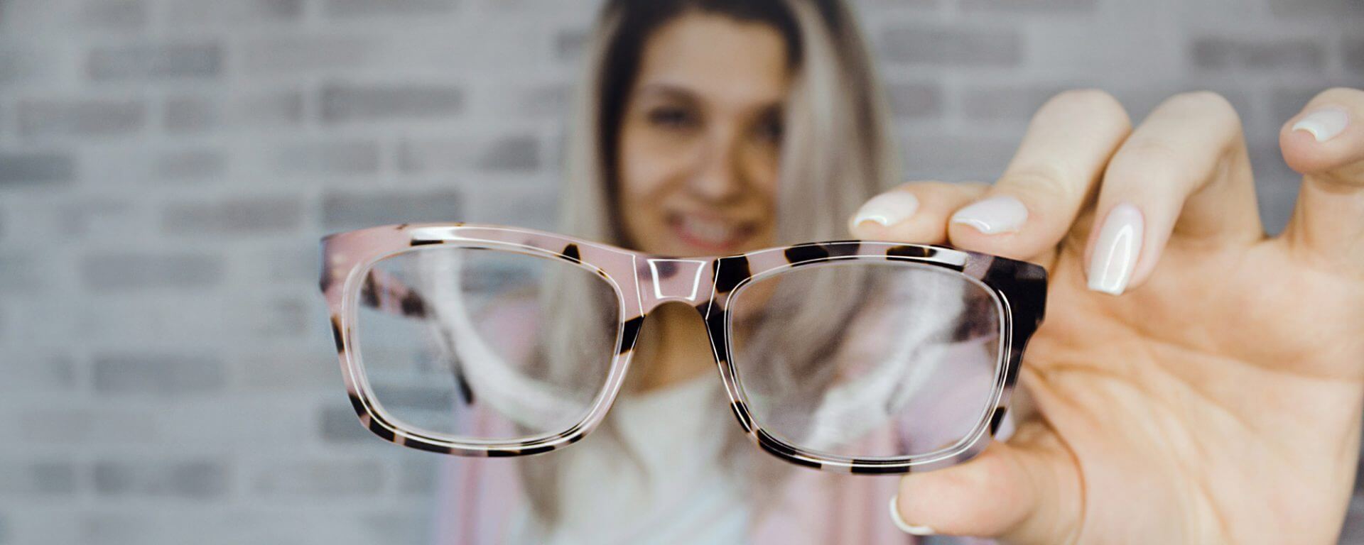 Girl Holding Up Glasses